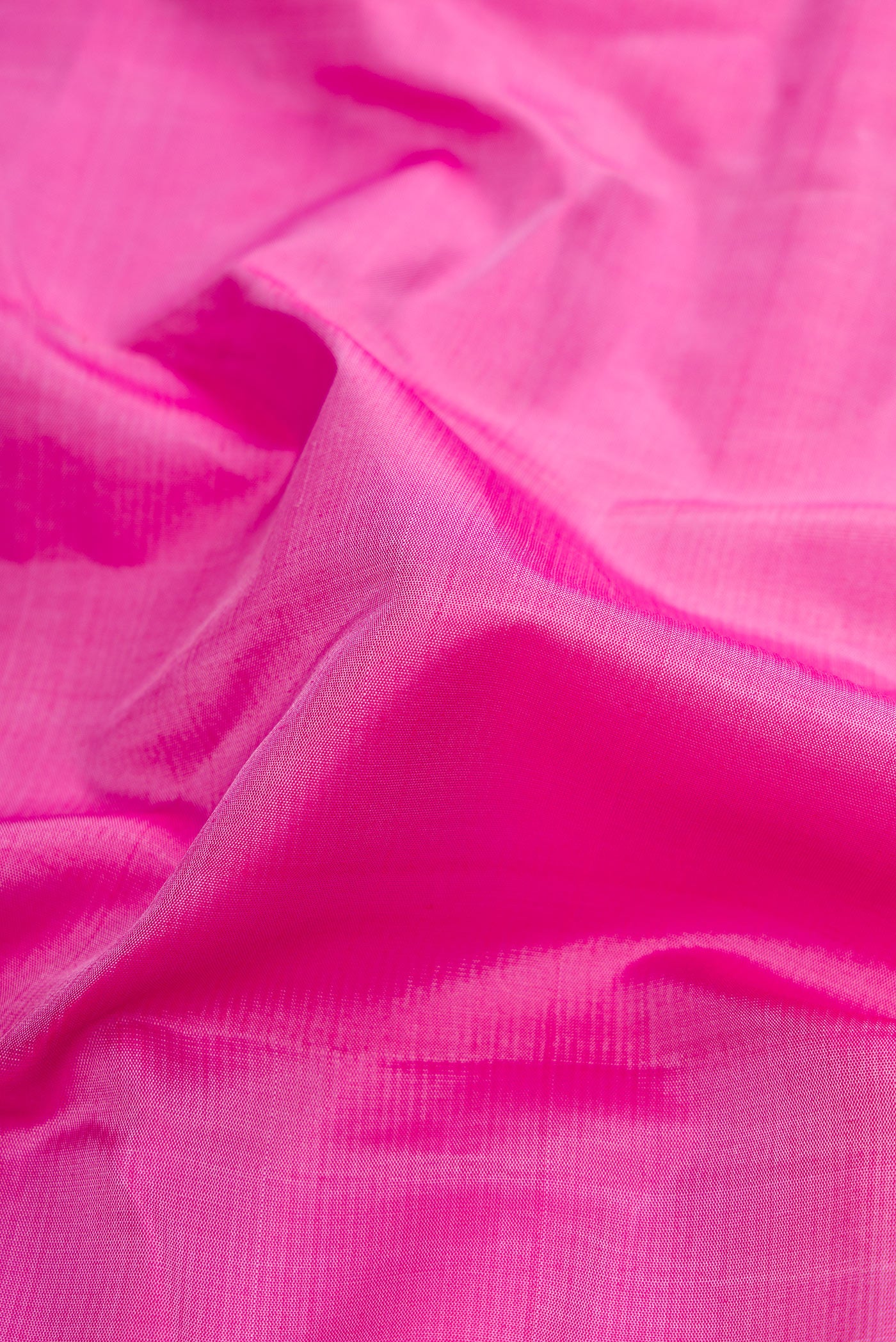 Close up of Pink Dual Tone Kanjivaram Silk Saree with Plain Body and Zari Border.  displaying folds