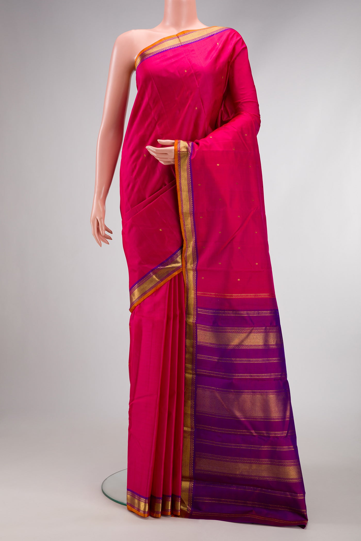 Dark Pink Dual Tone Kanchipuram Silk Saree with Zari Butta on the body and Zari Border.  displayed on a mannequin