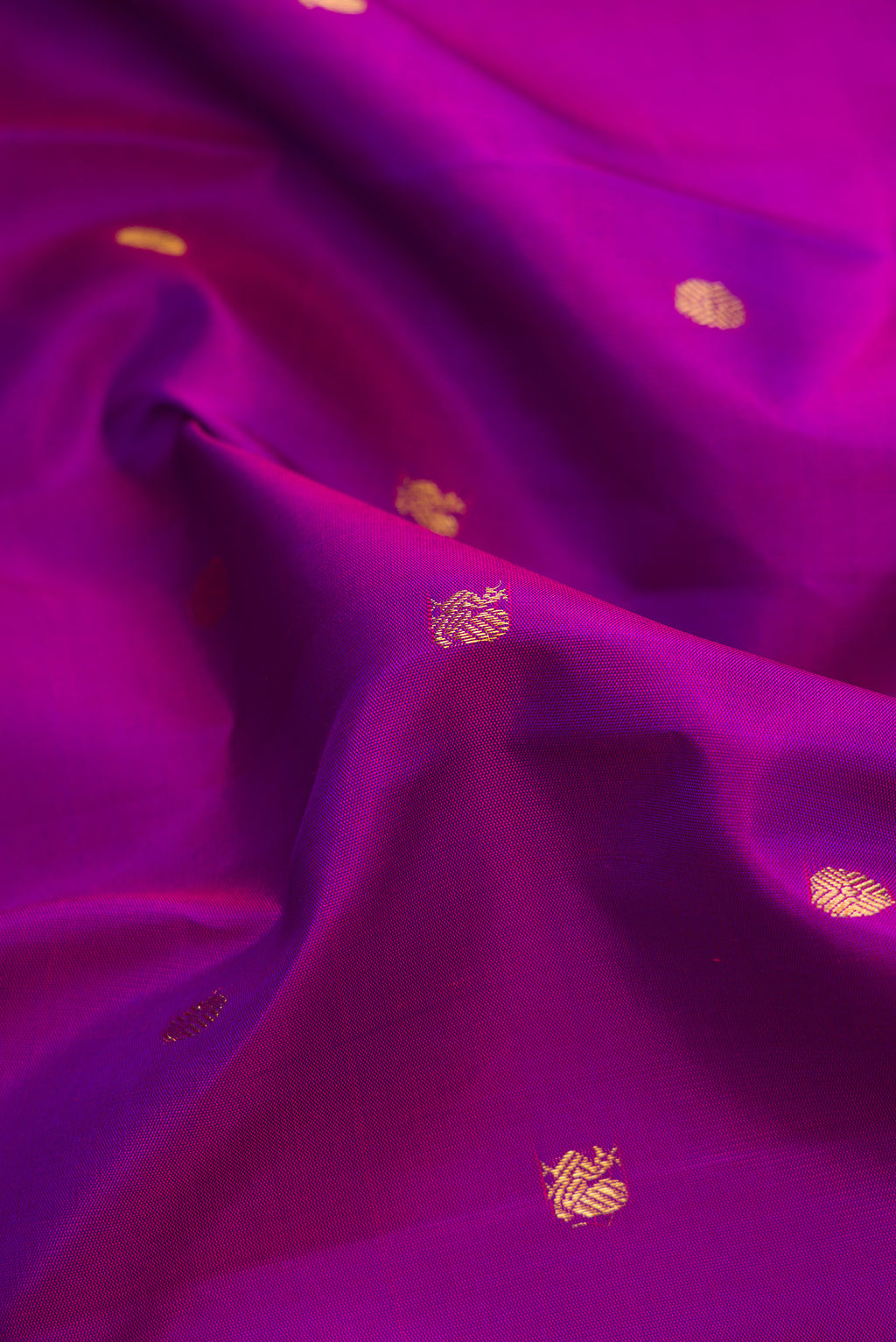 Close up of Purple Dual Tone Kanjivaram Silk Saree with Zari Butta on the body and Zari Border.  displaying folds