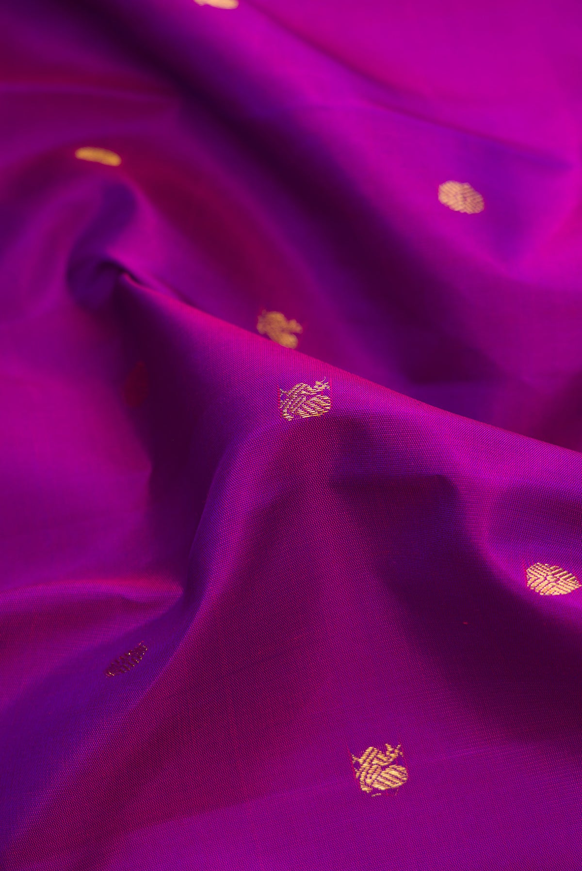 Close up of Purple Dual Tone Kanjivaram Silk Saree with Zari Butta on the body and Zari Border.  displaying folds