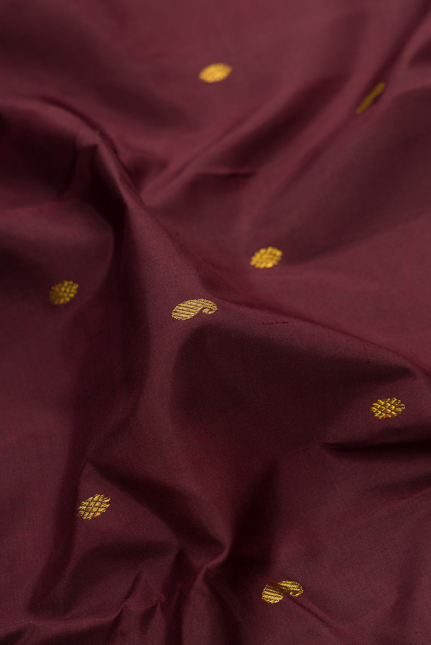 Close up of Coffee Brown Dual Tone Kanjivaram Silk Saree with Zari Butta on the body and Zari Border.  displaying folds