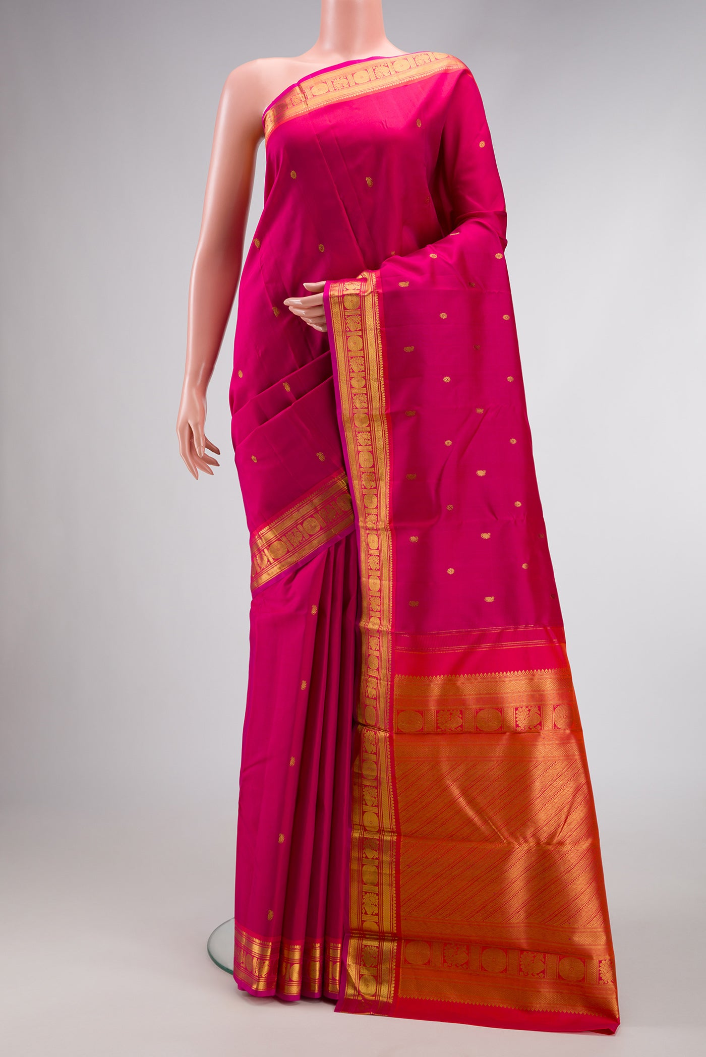 Dark Pink Dual Tone Kanjivaram Silk Saree with Zari Butta on the body and Zari Border.  displayed on a mannequin