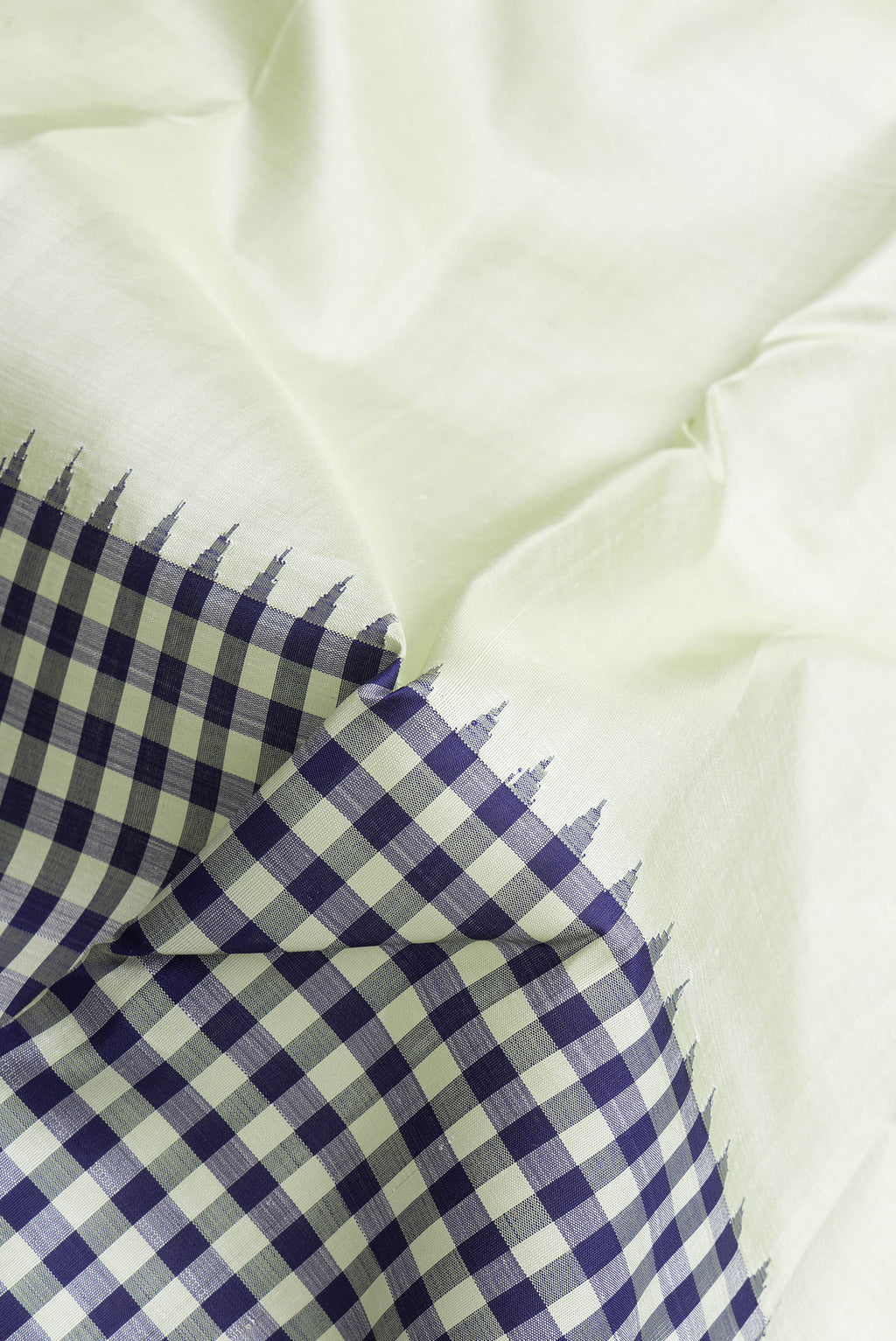 Close up of Pista Green Dual Tone Kanjivaram Silk Saree with Plain Body and Plain Border.  displaying folds
