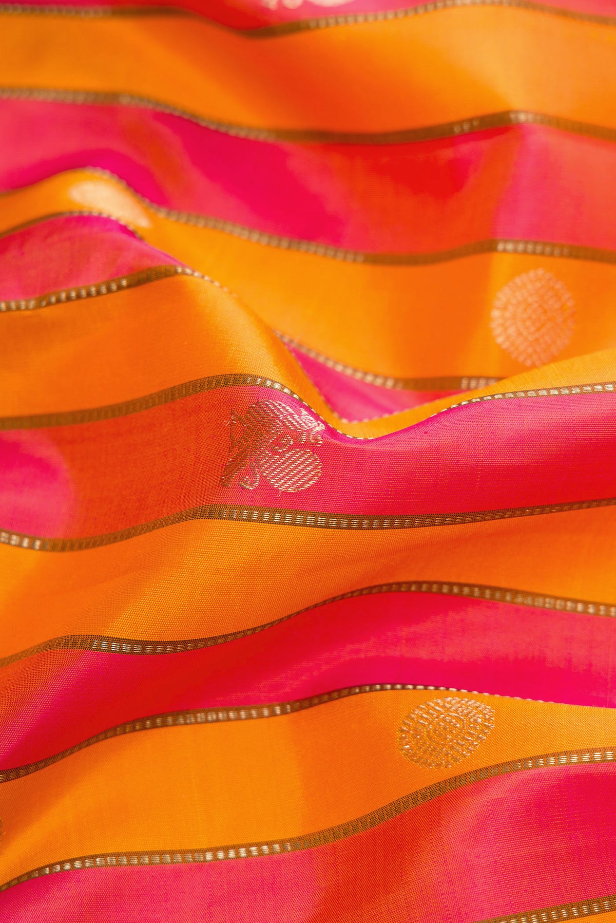 Close up of Orange and Pink Color Kanjivaram Silk Saree with Stripes on the body and Zari Border.  displaying folds