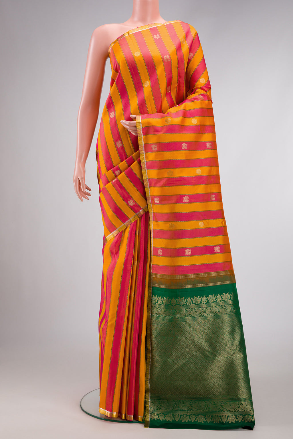 Orange and Pink Color Kanjivaram Silk Saree with Stripes on the body and Zari Border.  displayed on a mannequin