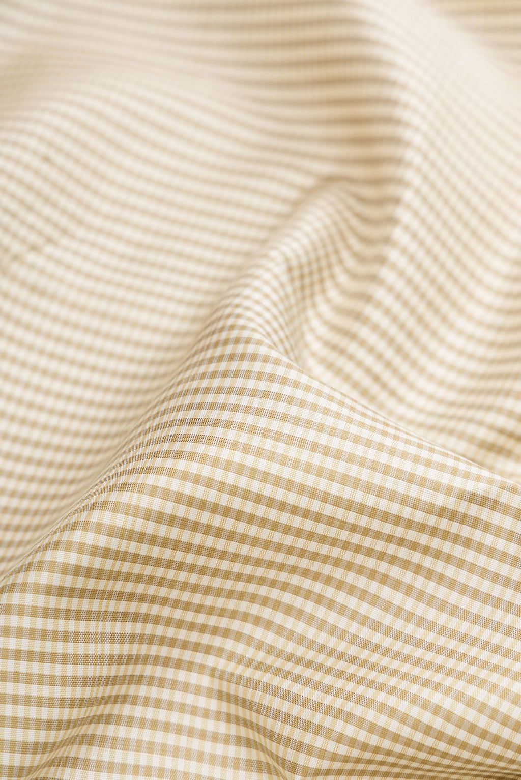 Close up of Off White Dual Tone Kanjivaram Silk Saree with Checked design on the body and Zari Border.  displaying folds