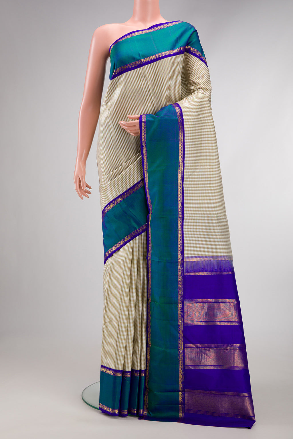 Off White Dual Tone Kanjivaram Silk Saree with Checked design on the body and Zari Border.  displayed on a mannequin