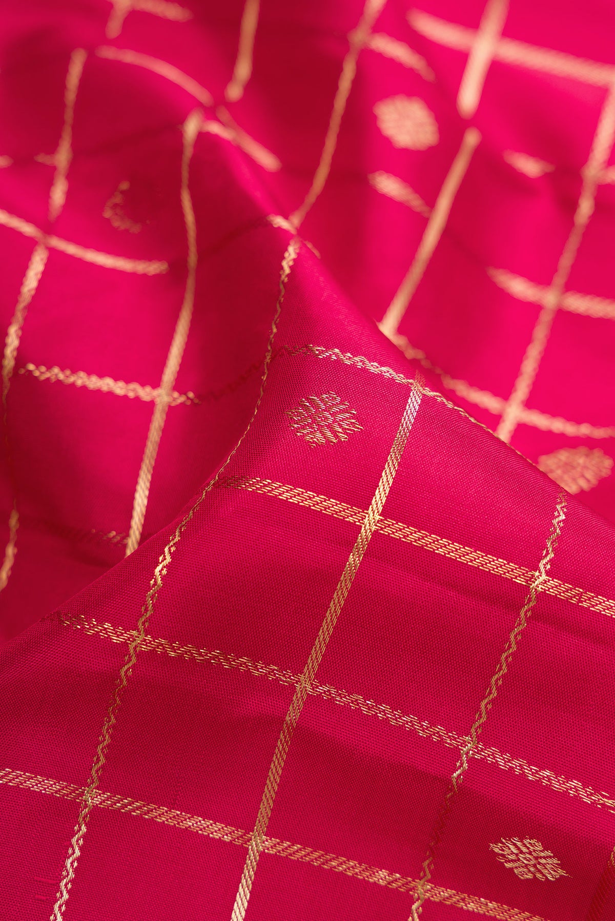Close up of Maroon Dual Tone Kanjivaram Silk Saree with Checked design on the body and Zari Border.  displaying folds