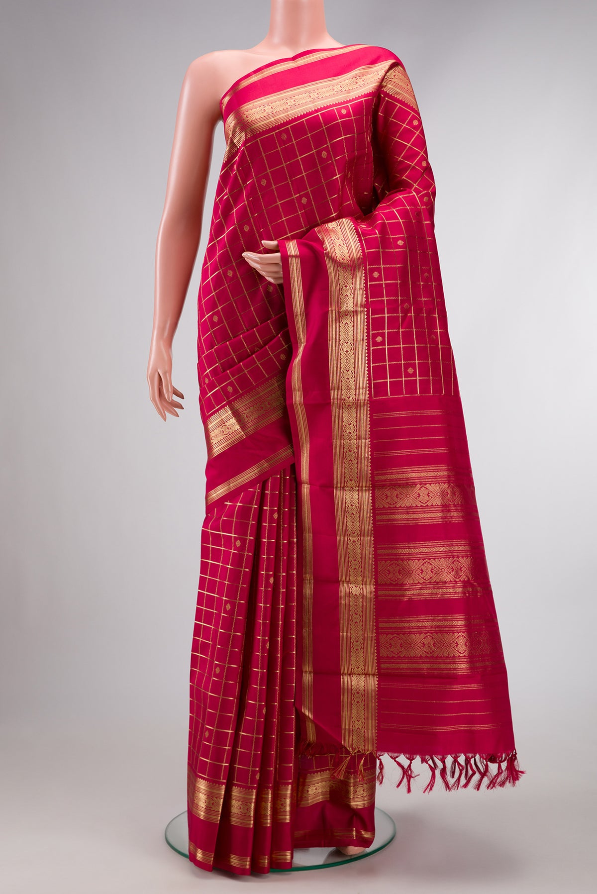 Maroon Dual Tone Kanjivaram Silk Saree with Checked design on the body and Zari Border.  displayed on a mannequin