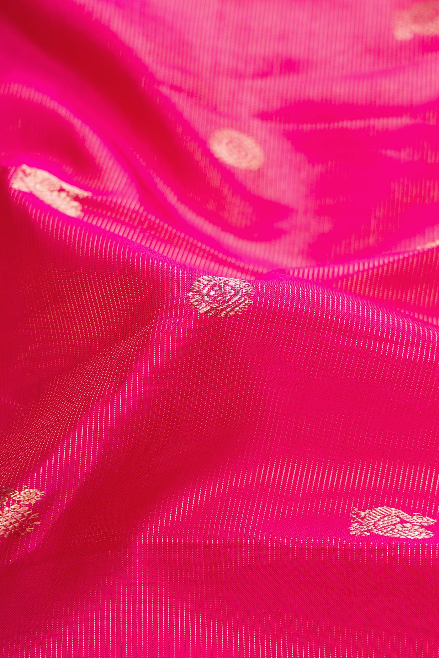 Close up of Pink Dual Tone Kanjivaram Silk Saree with Zari Butta on the body and Zari Border.  displaying folds