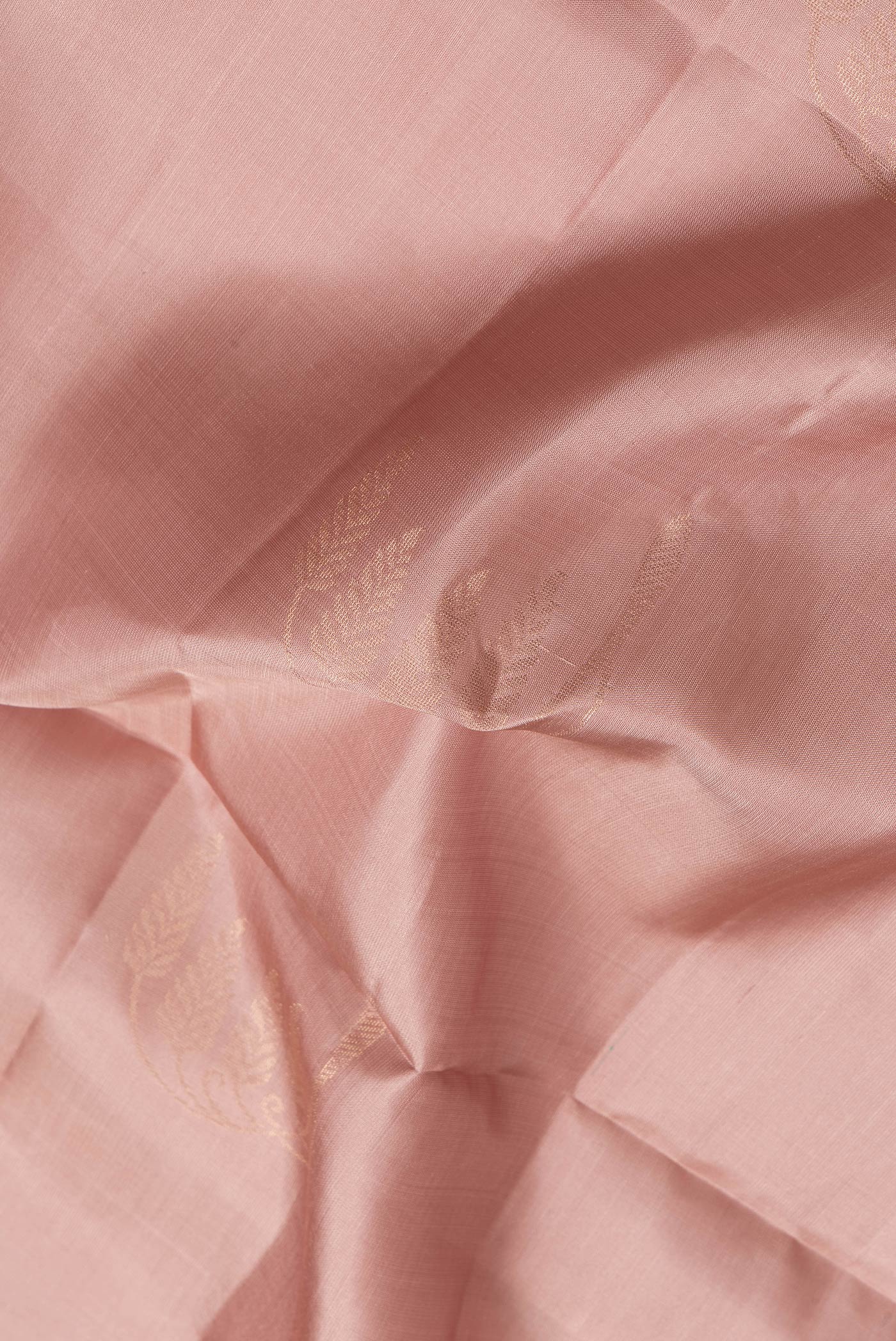 Close up of Rose Gold Dual Tone Soft Silk Saree with Zari Butta on the body and Zari Border.  displaying folds