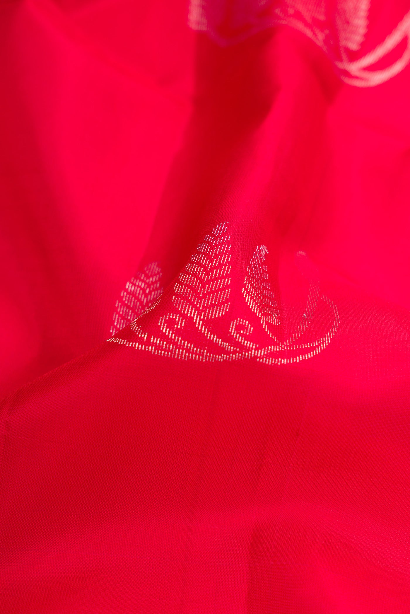 Close up of Red Dual Tone Soft Silk Saree with Zari Butta on the body and Zari Border.  displaying folds