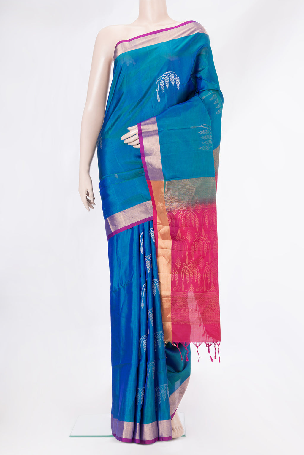 Peacock Blue Dual Tone Soft Silk Saree with Zari Butta on the body and Zari Border.  displayed on a mannequin