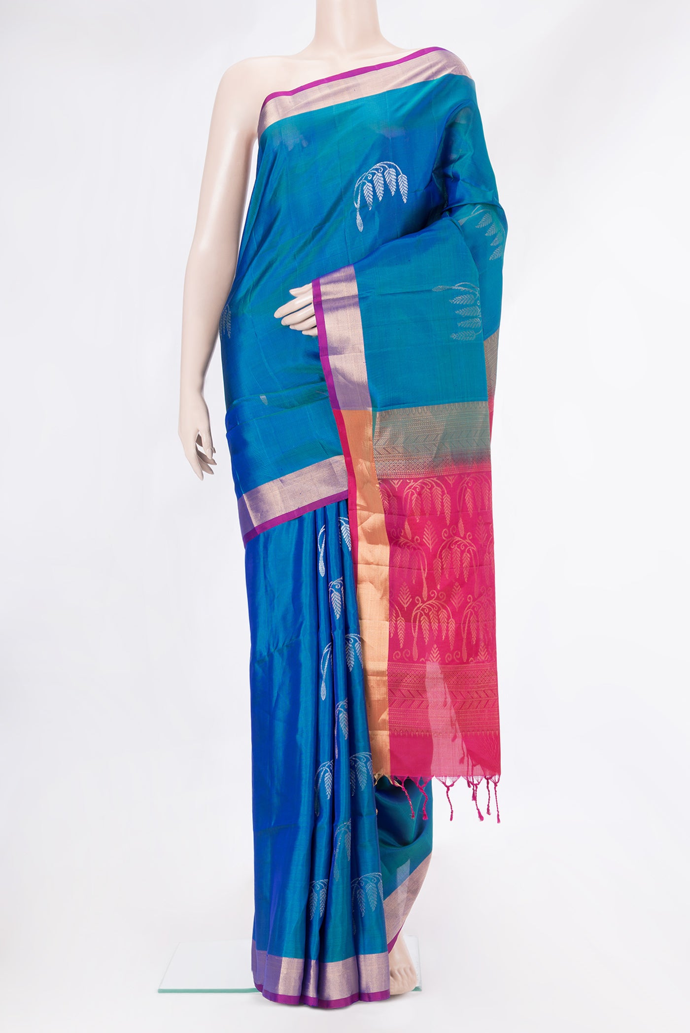 Peacock Blue Dual Tone Soft Silk Saree with Zari Butta on the body and Zari Border.  displayed on a mannequin