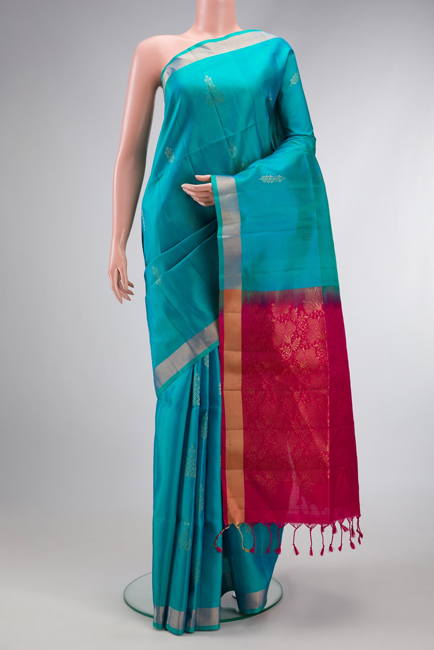 Sky Blue Dual Tone Soft Silk Saree with Zari Butta on the body and Zari Border.  displayed on a mannequin