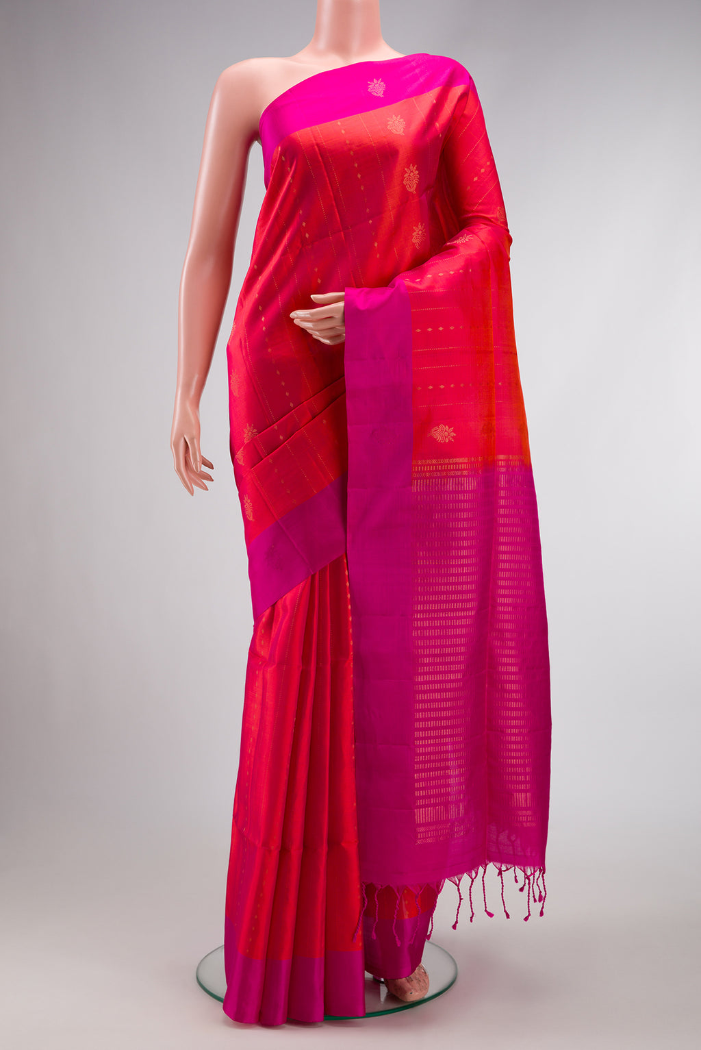 Coral Dual Tone Soft Silk Saree with Zari Butta on the body and Fancy Border.  displayed on a mannequin