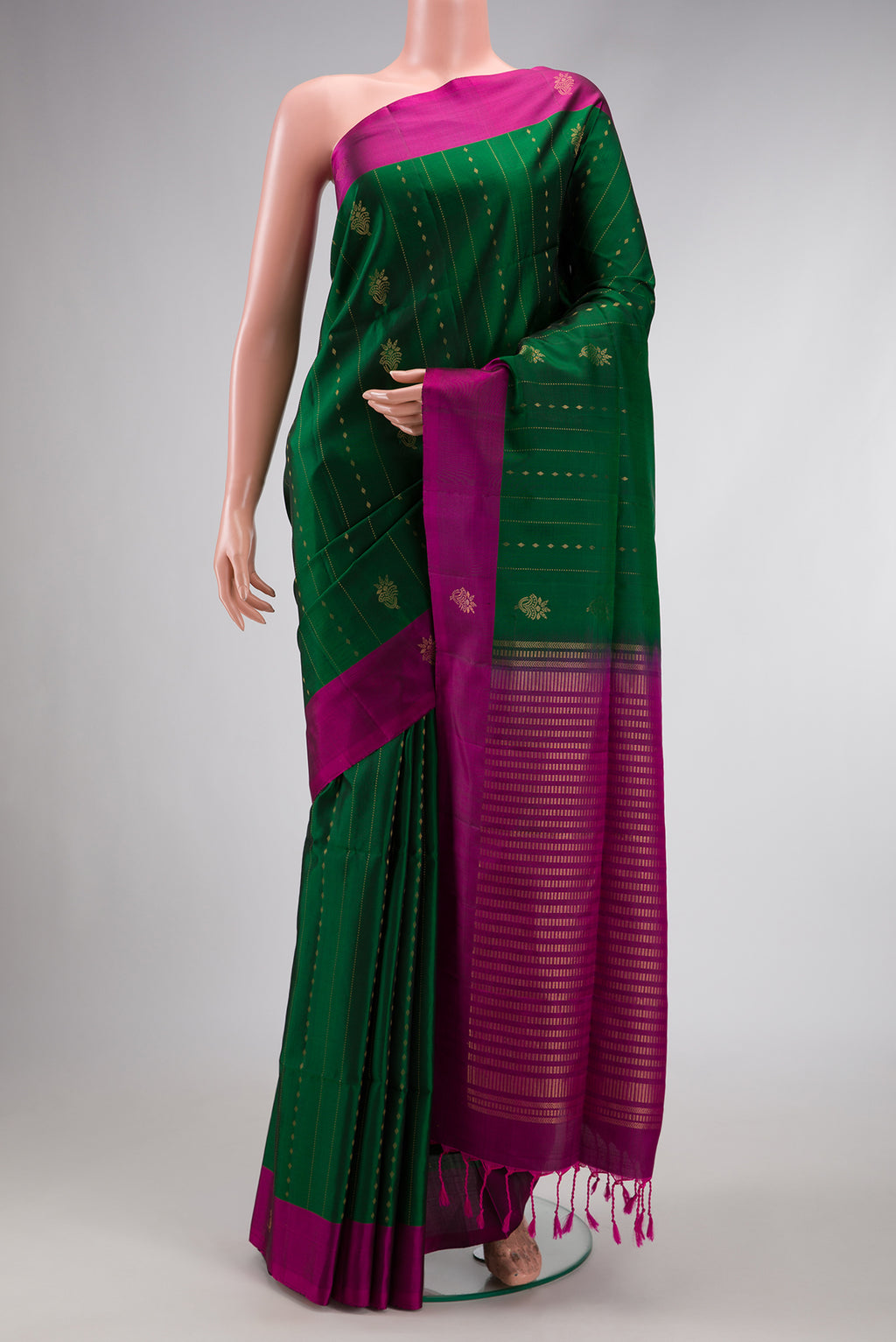 Green Dual Tone Soft Silk Saree with Zari Butta on the body and Zari Border.  displayed on a mannequin