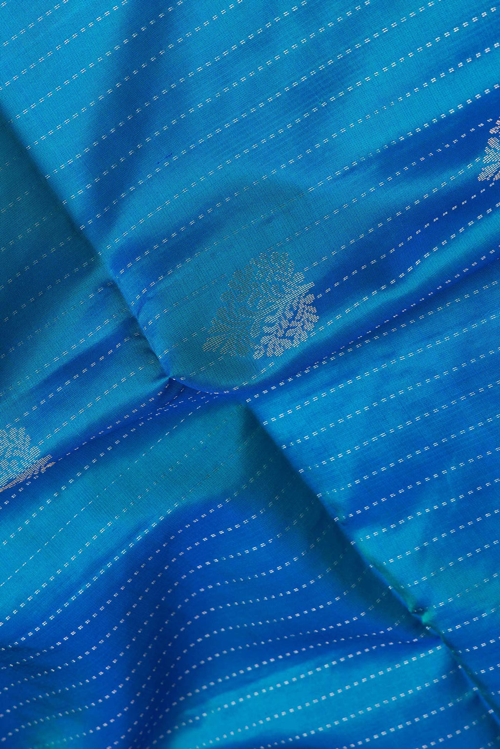 Close up of Peacock Blue Dual Tone Soft Silk Saree with Stripes on the body and Without Border.  displaying folds