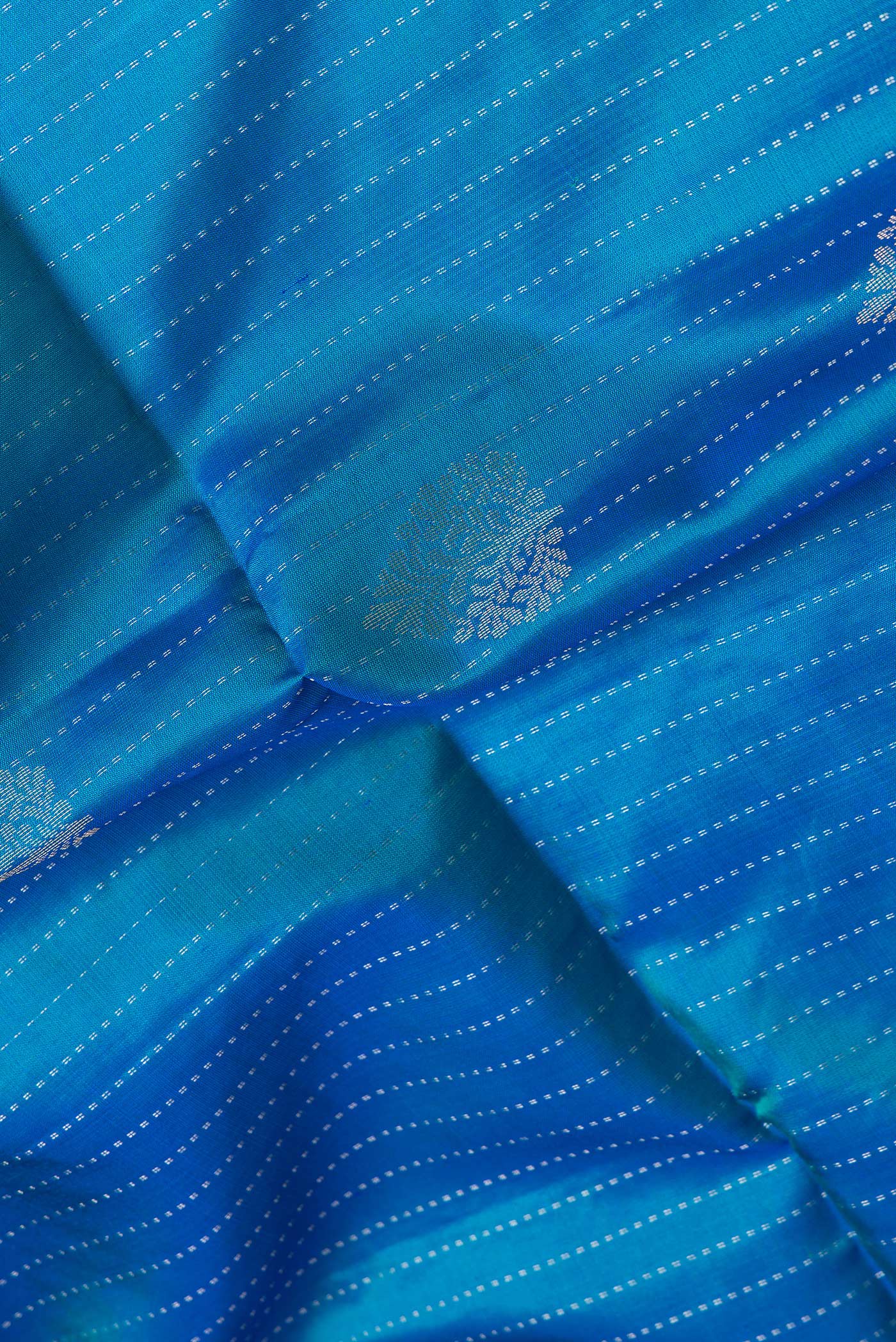 Close up of Peacock Blue Dual Tone Soft Silk Saree with Stripes on the body and Without Border.  displaying folds