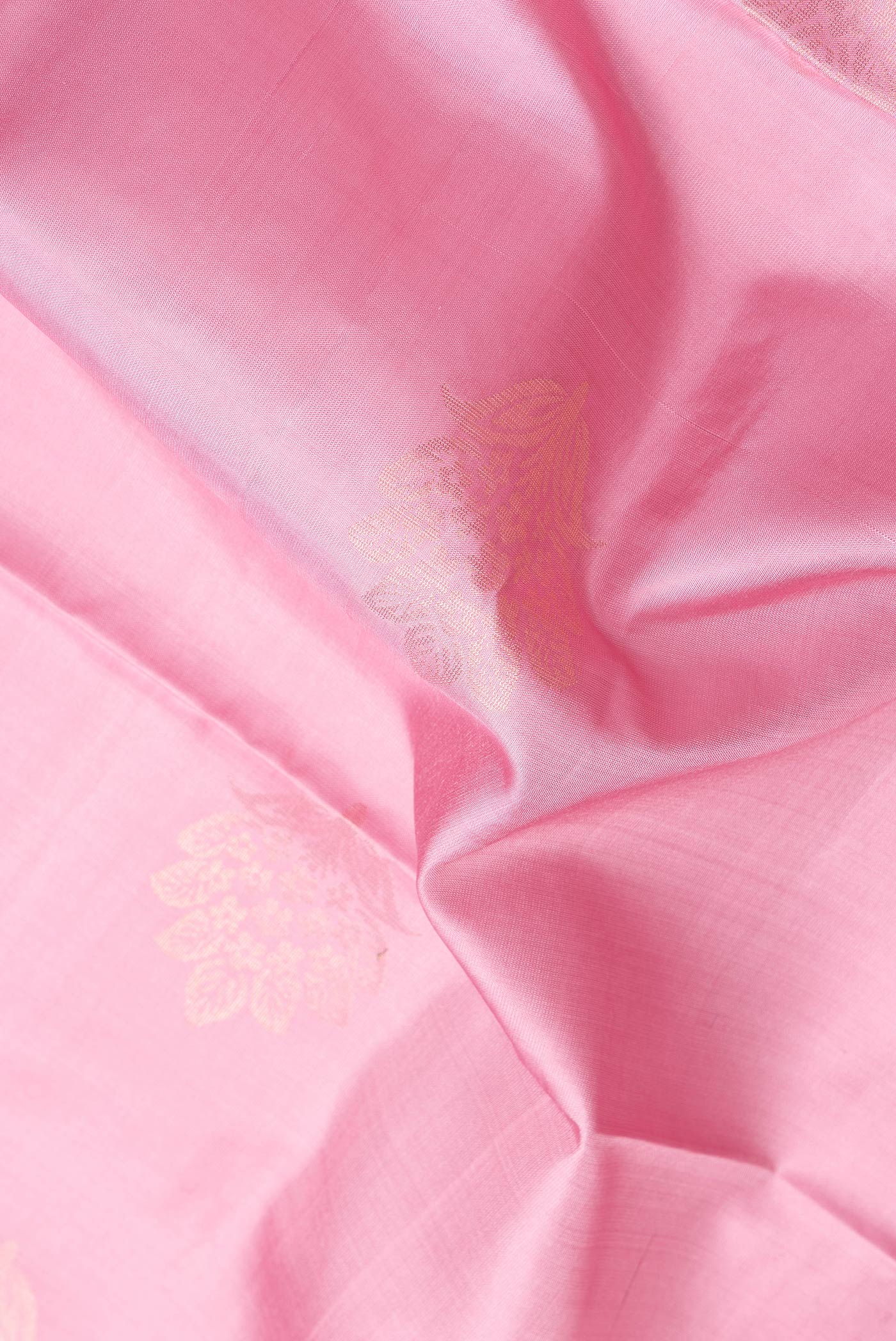 Close up of Pink Dual Tone Soft Silk Saree with Zari Butta on the body and Zari Border.  displaying folds