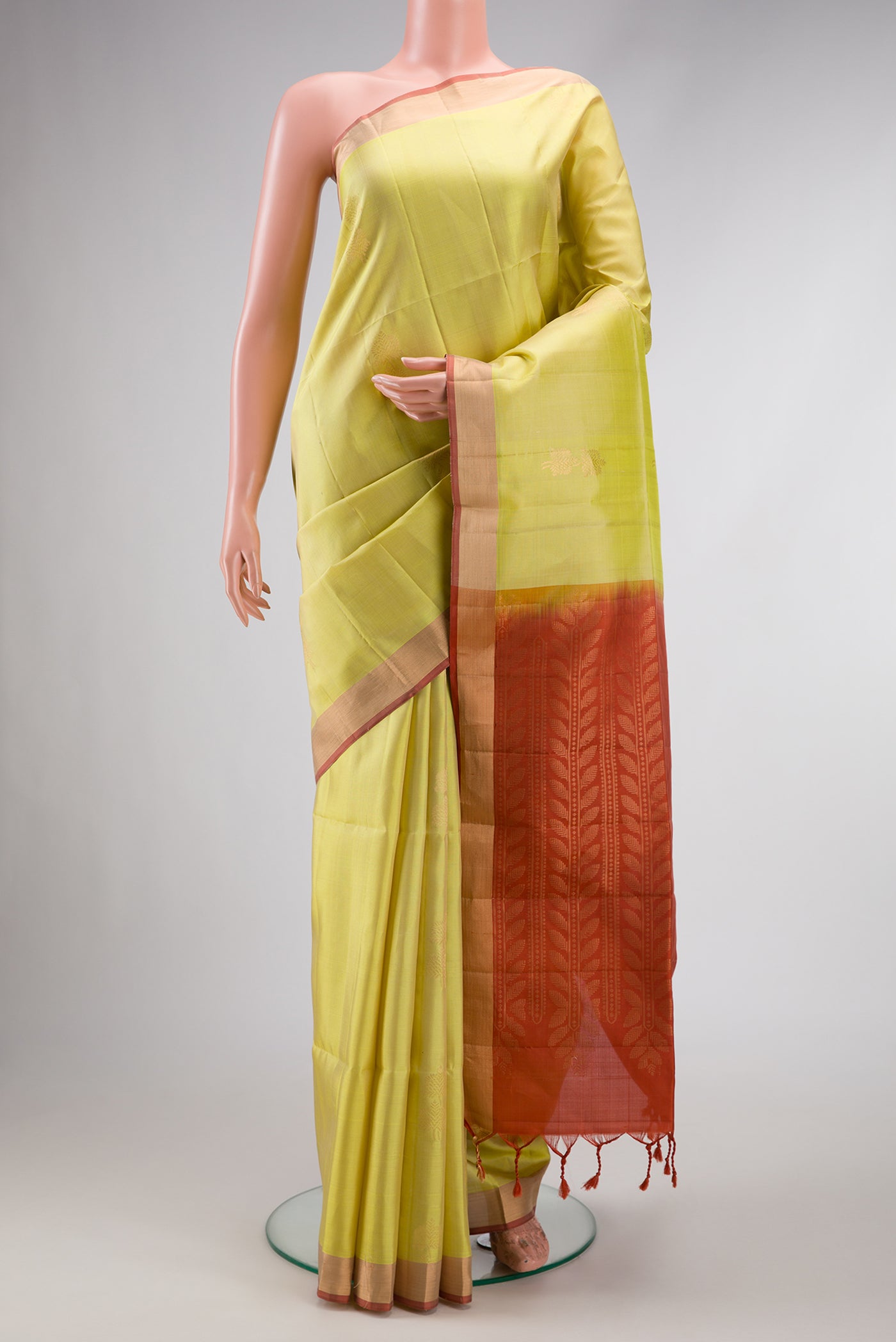 Pista Green Dual Tone Soft Silk Saree with Zari Butta on the body and Zari Border.  displayed on a mannequin