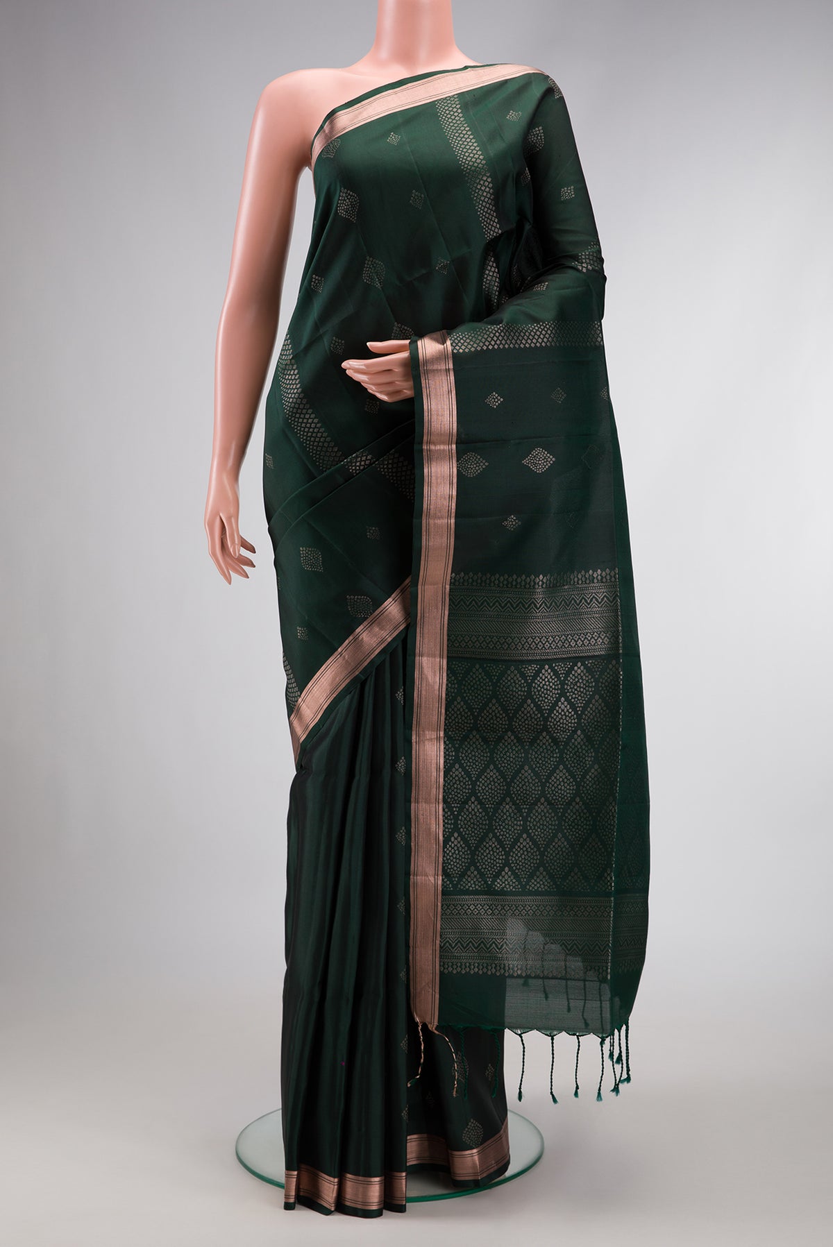 Bottle Green Dual Tone Soft Silk Saree with Zari Butta on the body and Zari Border.  displayed on a mannequin