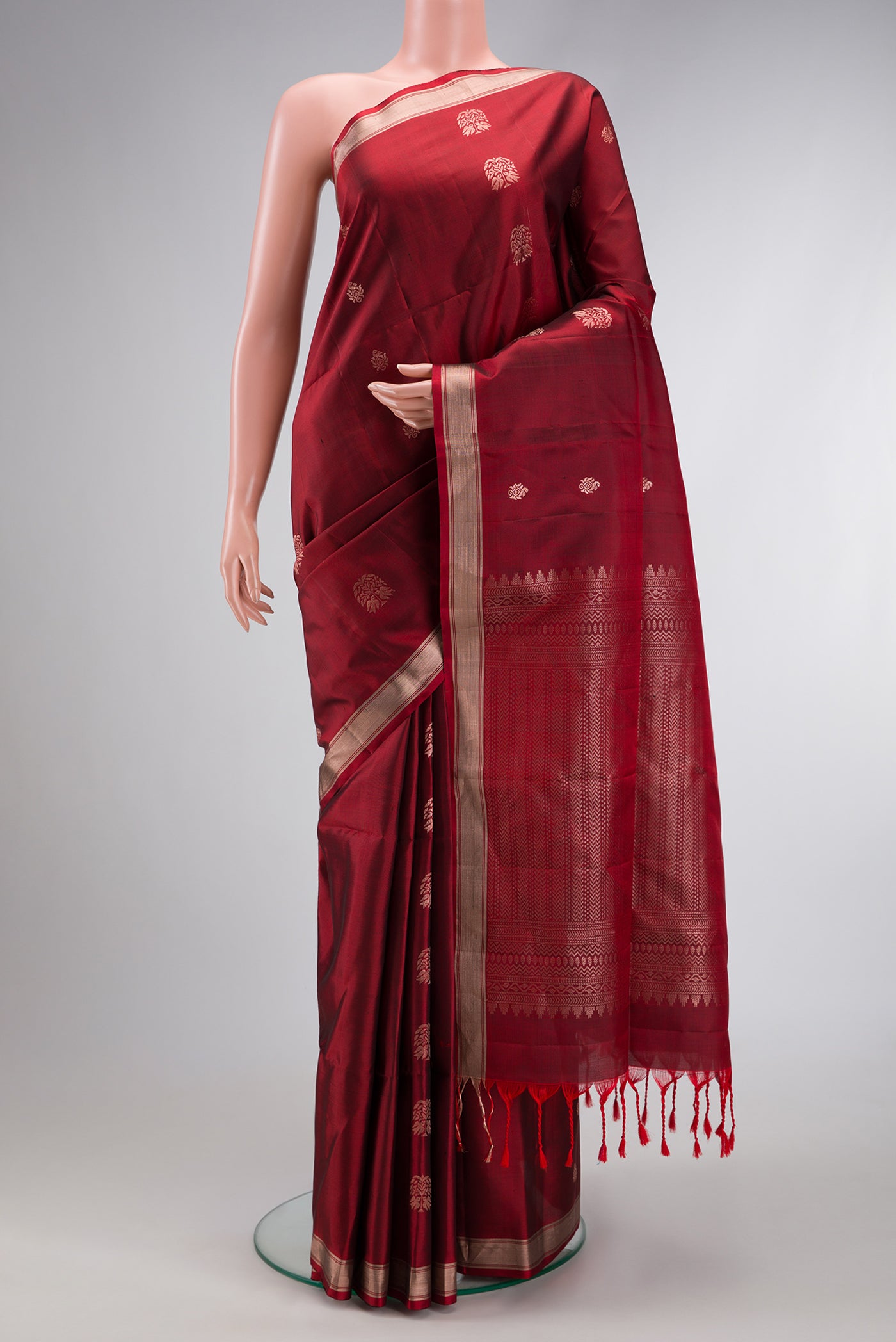 Maroon Dual Tone Soft Silk Saree with Zari Butta on the body and Zari Border.  displayed on a mannequin