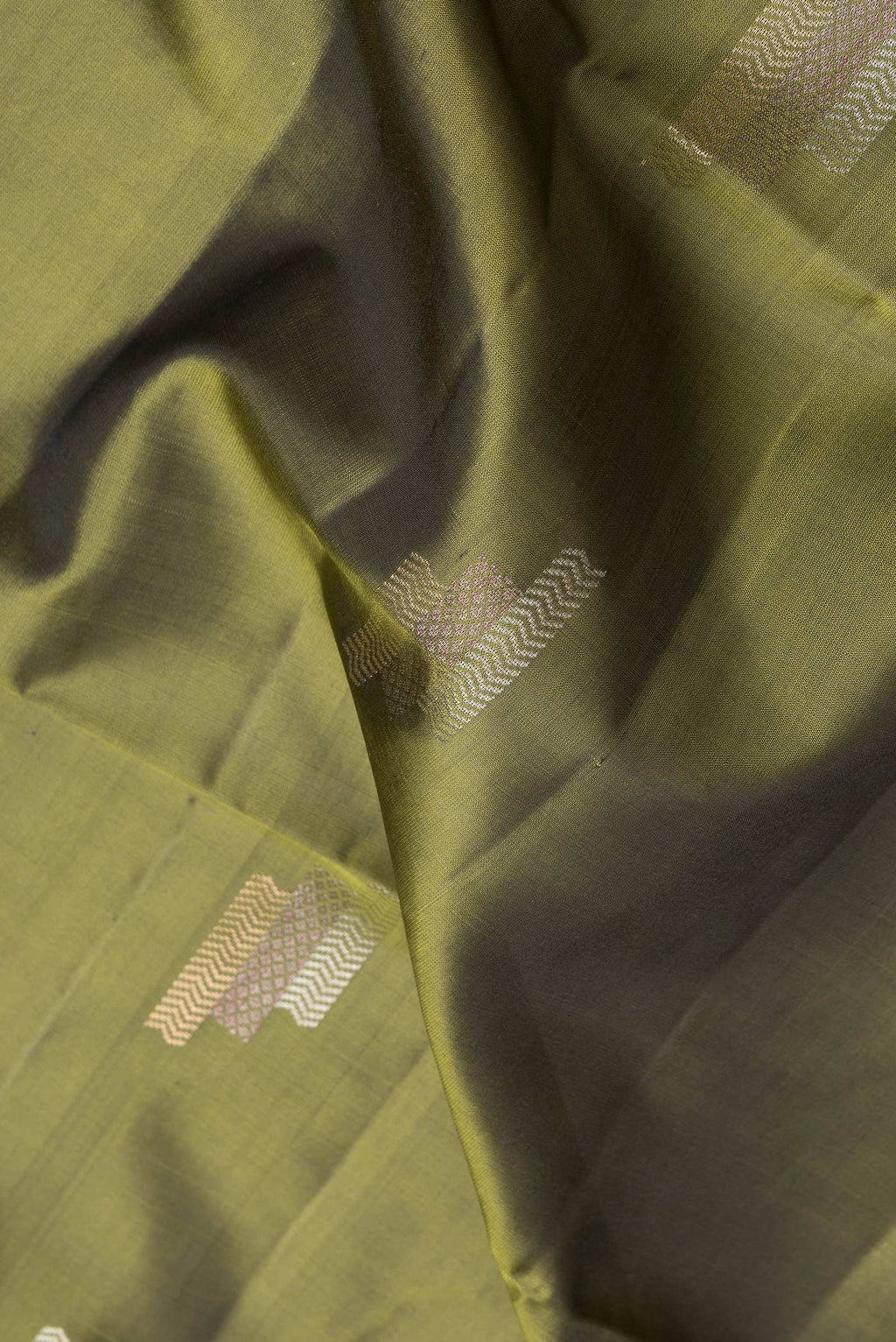 Close up of Mehandi Green Dual Tone Soft Silk Saree with Zari Butta on the body and Zari Border.  displaying folds
