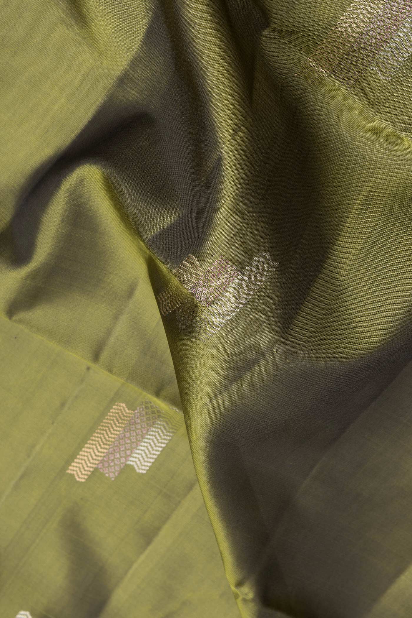 Close up of Mehandi Green Dual Tone Soft Silk Saree with Zari Butta on the body and Zari Border.  displaying folds