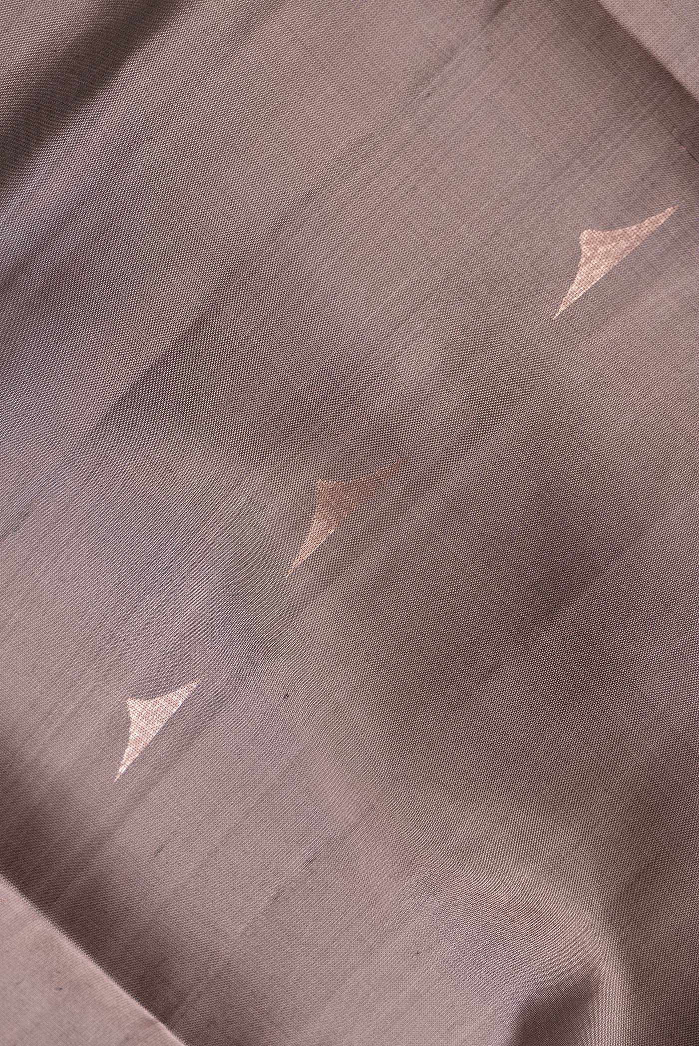 Close up of Brown Dual Tone Soft Silk Saree with Zari Butta on the body and Zari Border.  displaying folds