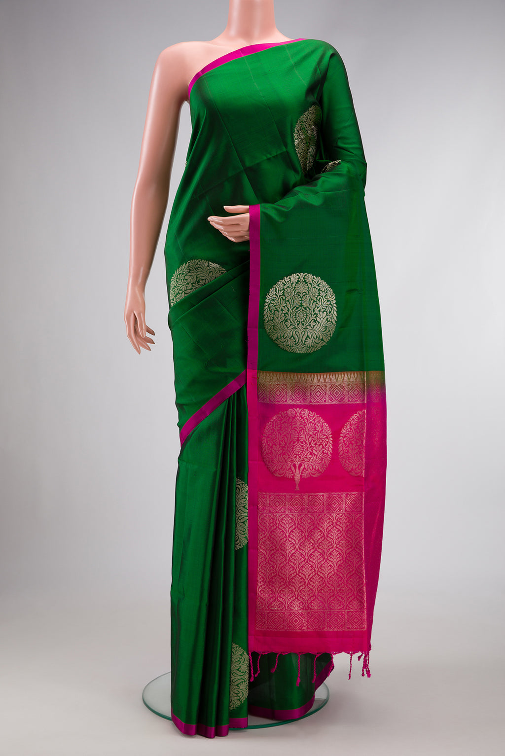 Green Dual Tone Soft Silk Saree with Zari Butta on the body and Plain Border.  displayed on a mannequin