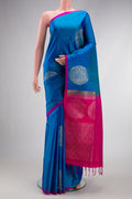 Peacock Blue Dual Tone Soft Silk Saree with Zari Butta on the body and Plain Border.  displayed on a mannequin