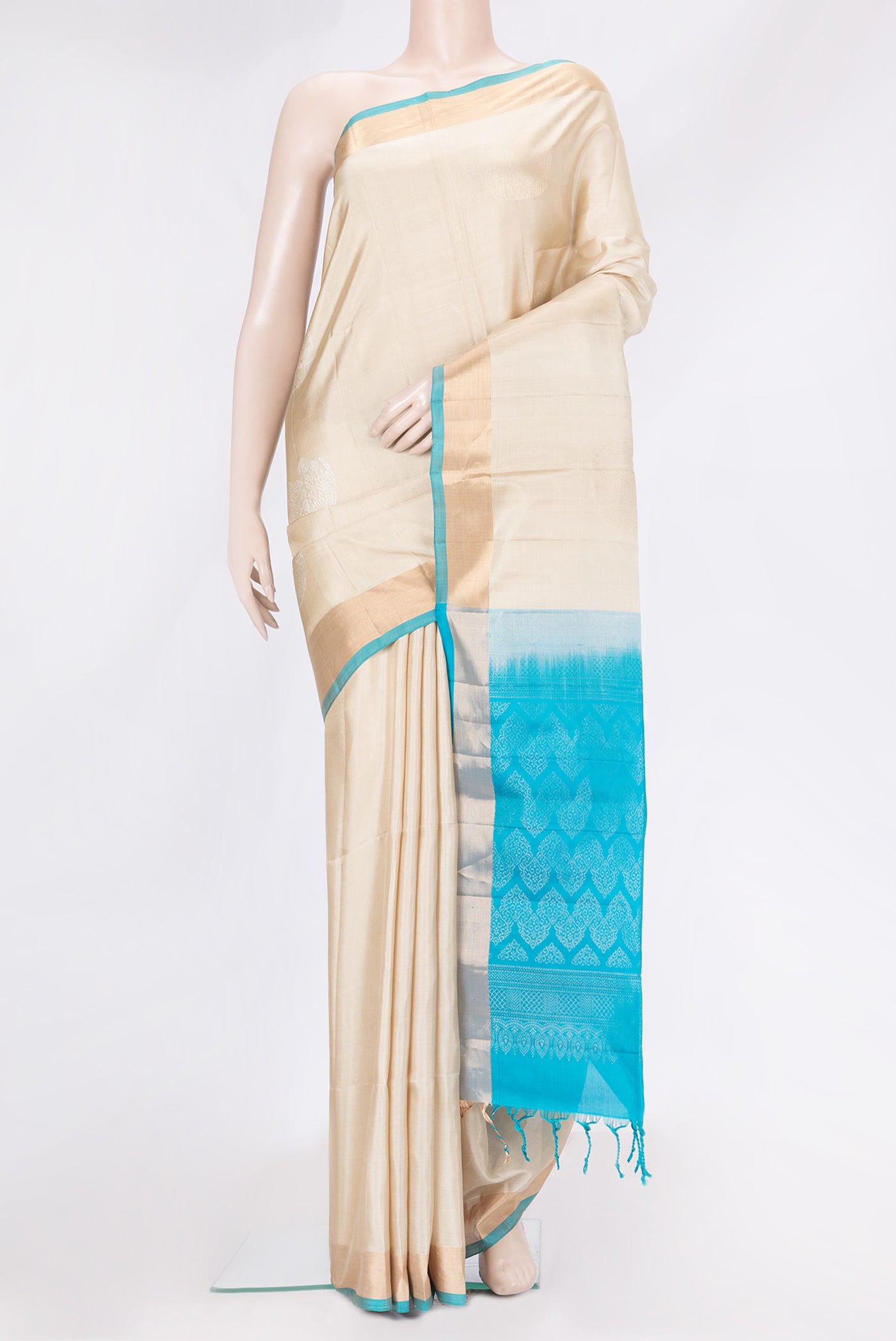 Beige Dual Tone Soft Silk Saree with Zari Butta on the body and Zari Border.  displayed on a mannequin