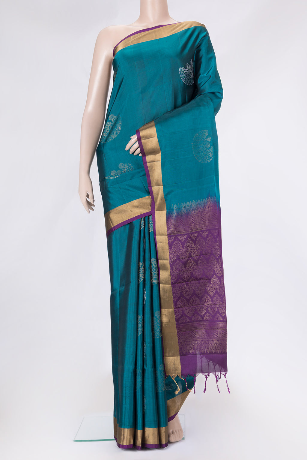 Peacock Blue Dual Tone Soft Silk Saree with Zari Butta on the body and Zari Border.  displayed on a mannequin