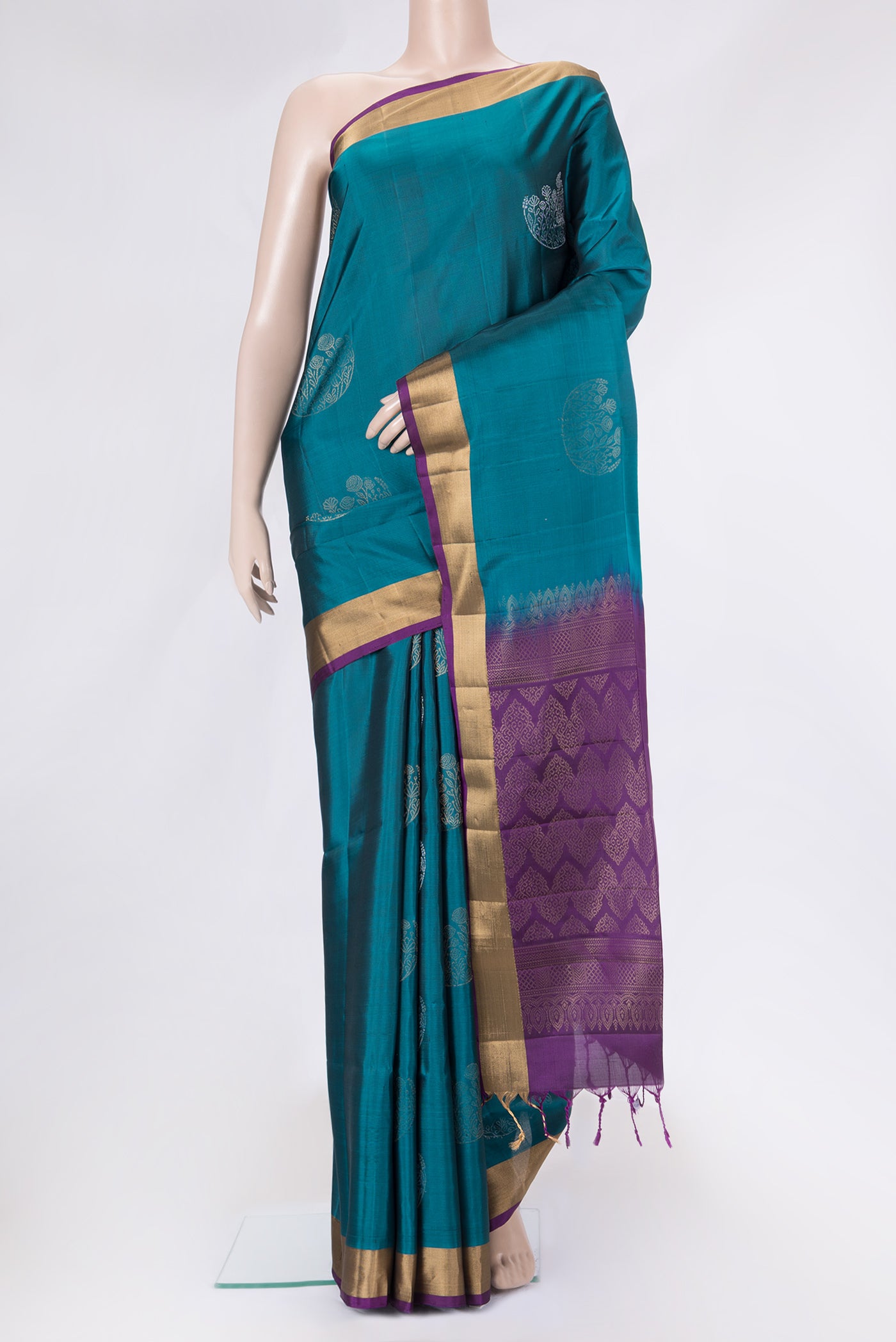 Peacock Blue Dual Tone Soft Silk Saree with Zari Butta on the body and Zari Border.  displayed on a mannequin