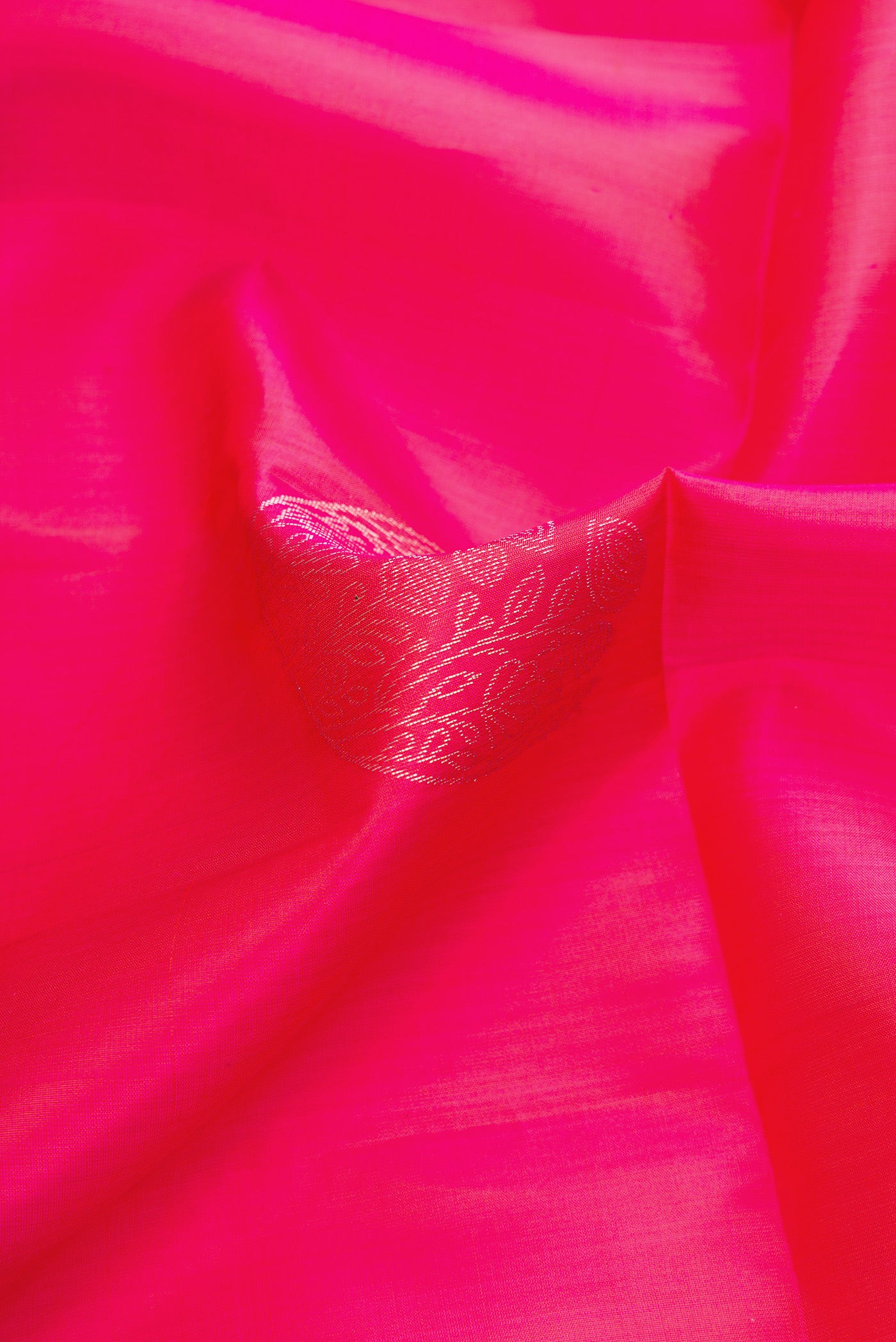 Close up of Pink Dual Tone Soft Silk Saree with Zari Butta on the body and Zari Border.  displaying folds
