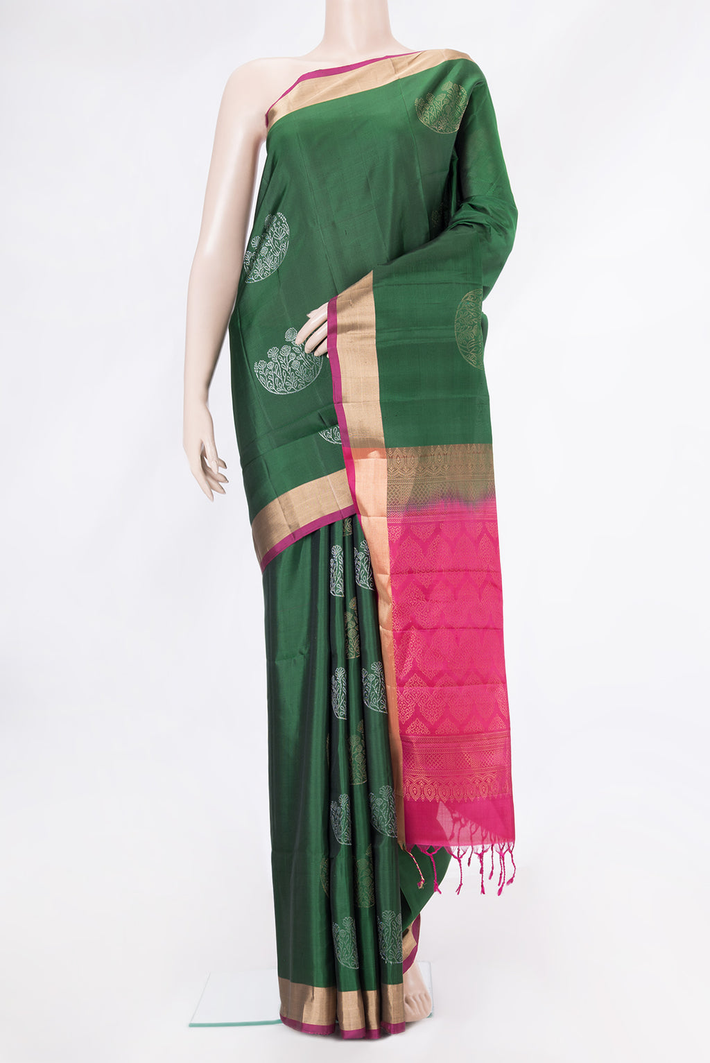 Bottle Green Soft Silk Saree with Zari Butta on the body and Zari Border.  displayed on a mannequin