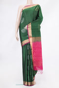 Bottle Green Soft Silk Saree with Zari Butta on the body and Zari Border.  displayed on a mannequin