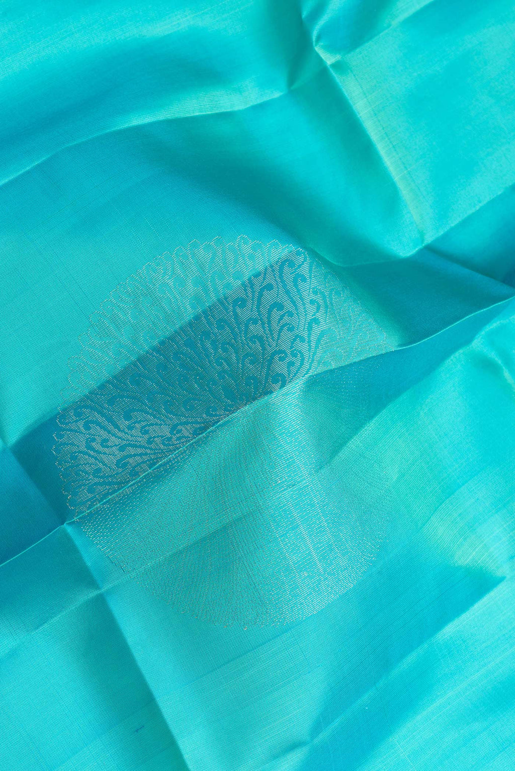 Close up of Sky Blue Dual Tone Soft Silk Saree with Zari Butta on the body and Zari Border.  displaying folds