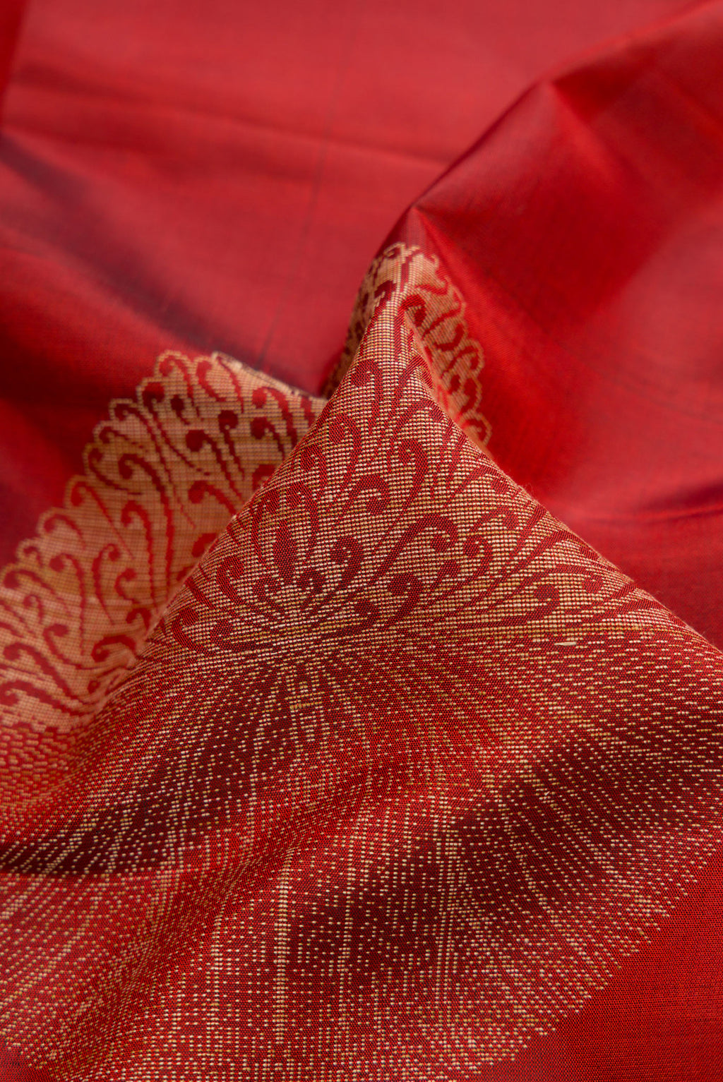 Close up of Maroon Dual Tone Soft Silk Saree with Zari Butta on the body and Zari Border.  displaying folds