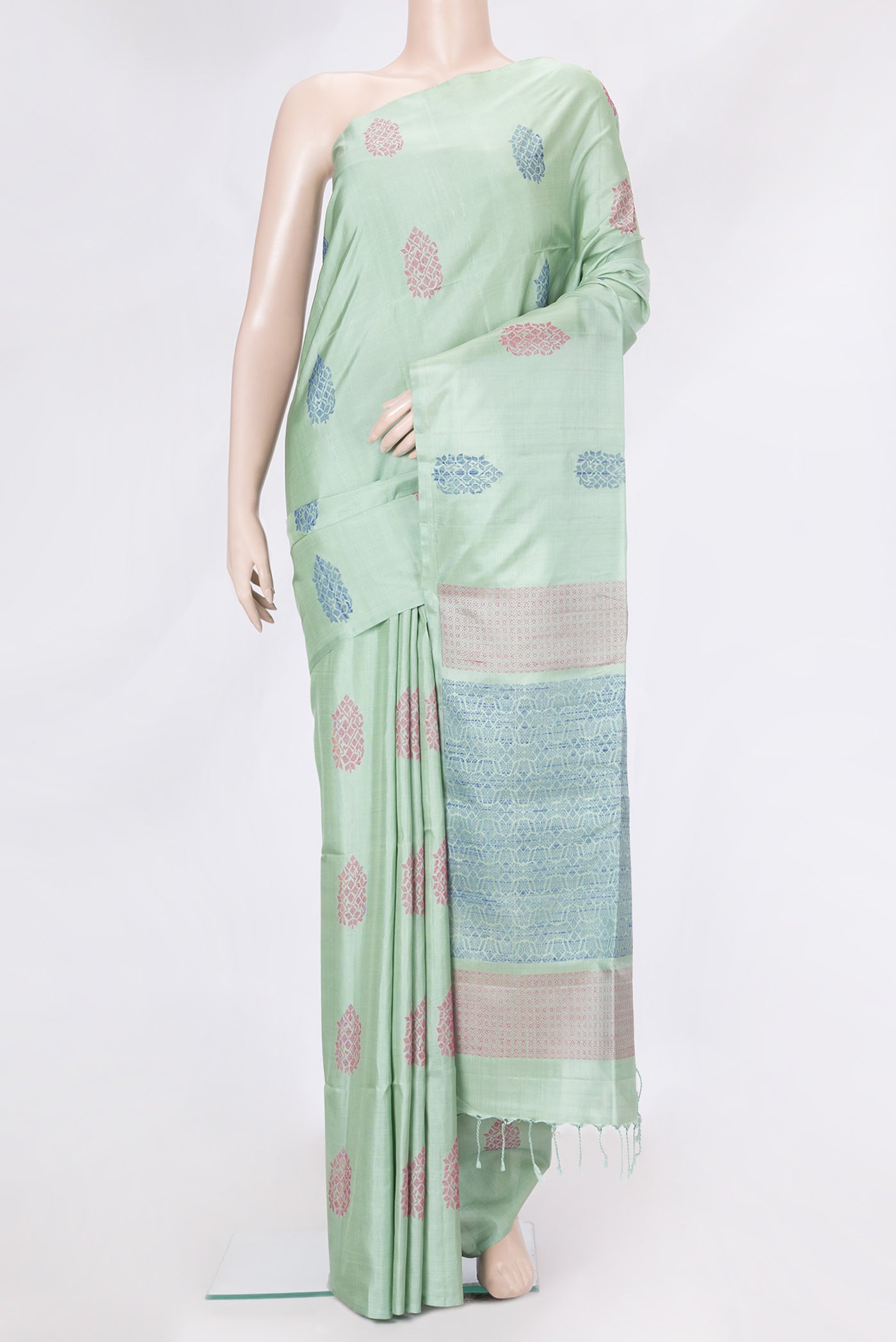 Pista Green Dual Tone Soft Silk Saree with Zari Butta on the body and Without Border.  displayed on a mannequin