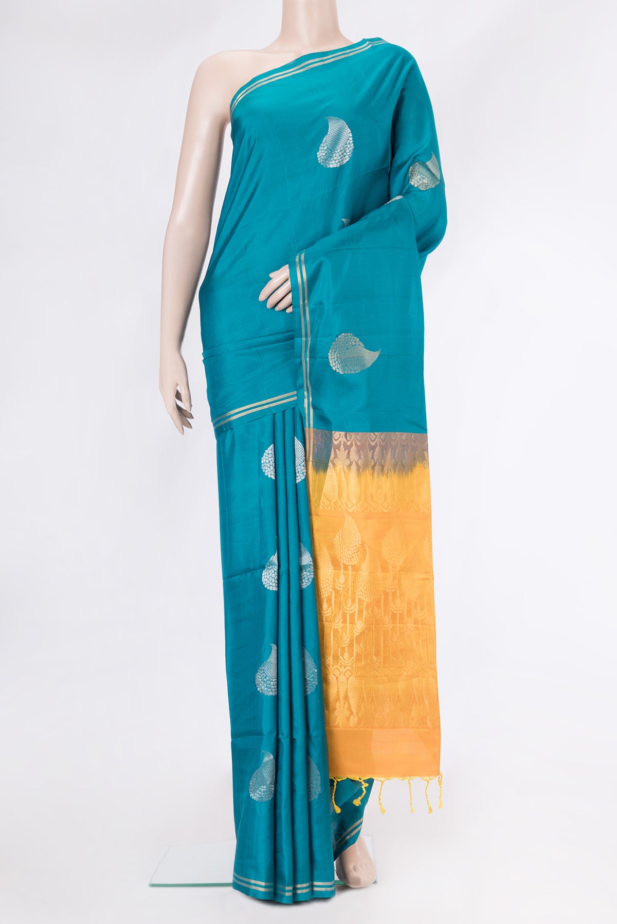 Peacock Blue Soft Silk Saree with Zari Butta on the body and Zari Border.  displayed on a mannequin