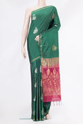 Green Soft Silk Saree with Zari Butta on the body and Zari Border.  displayed on a mannequin