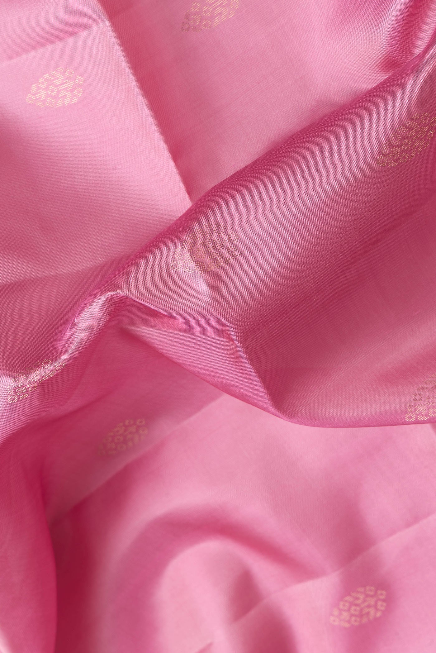 Close up of Pink Dual Tone Soft Silk Saree with Zari Butta on the body and Zari Border.  displaying folds
