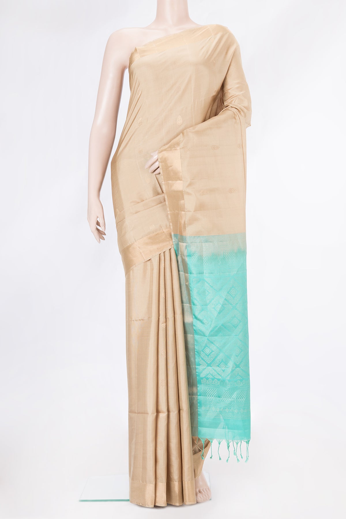 Beige Soft Silk Saree with Zari Butta on the body and Zari Border.  displayed on a mannequin