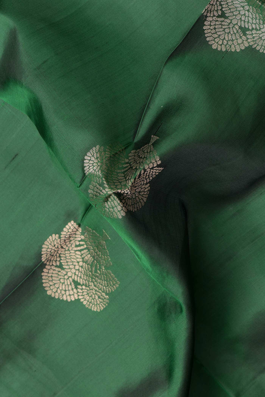 Close up of Bottle Green Dual Tone Soft Silk Saree with Zari Butta on the body and Zari Border.  displaying folds
