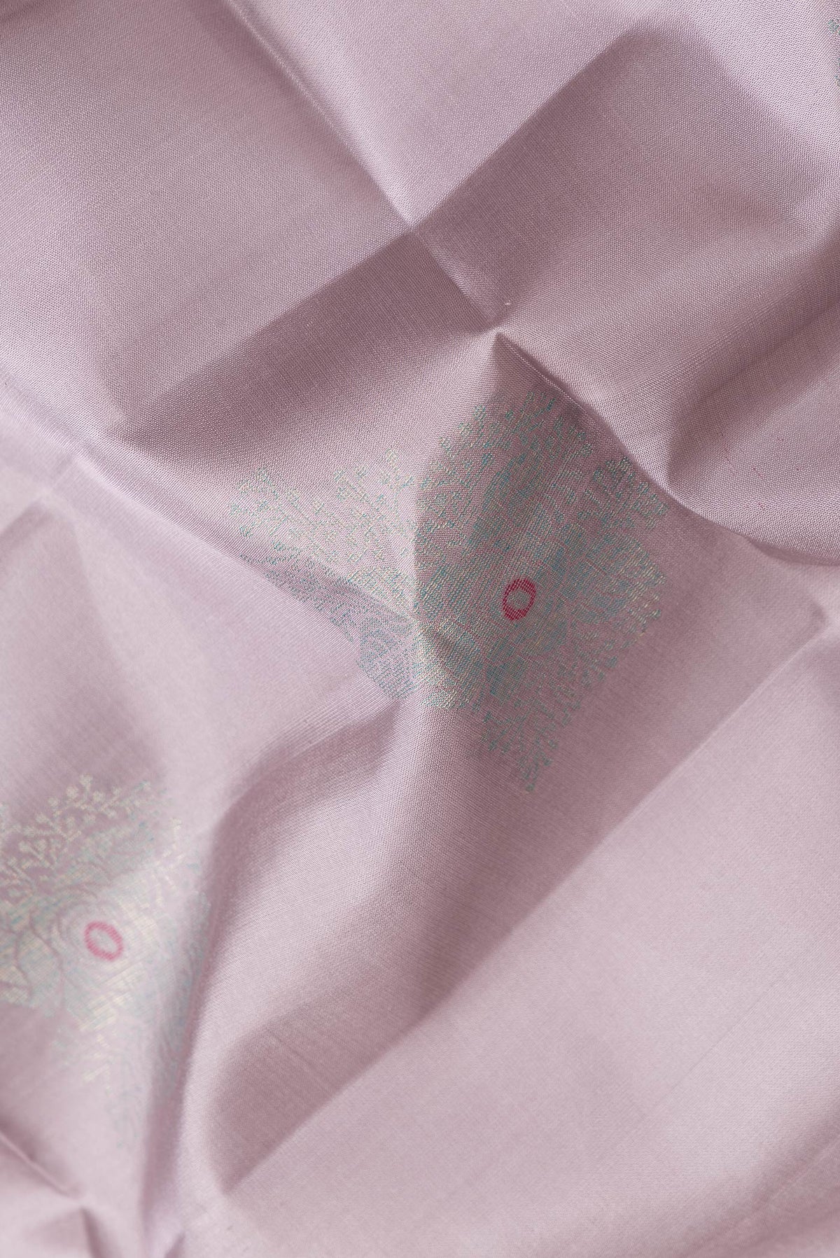 Close up of Lavender Dual Tone Soft Silk Saree with Zari Butta on the body and Zari Border.  displaying folds