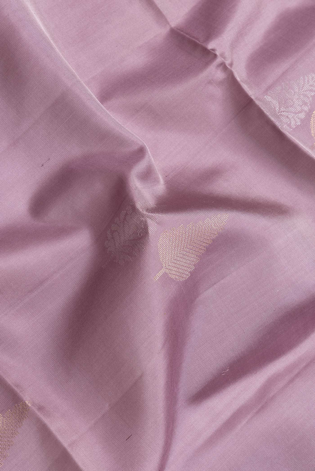 Close up of Lavender Dual Tone Soft Silk Saree with Zari Butta on the body and Zari Border.  displaying folds