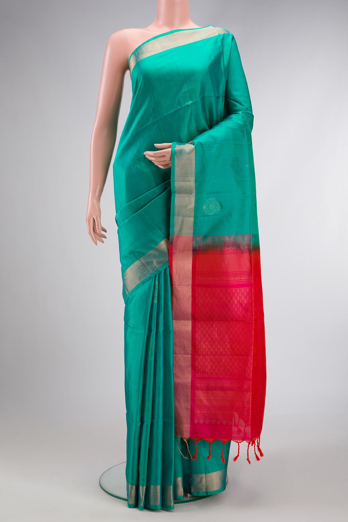Sea Green Dual Tone Soft Silk Saree with Zari Butta on the body and Zari Border.  displayed on a mannequin