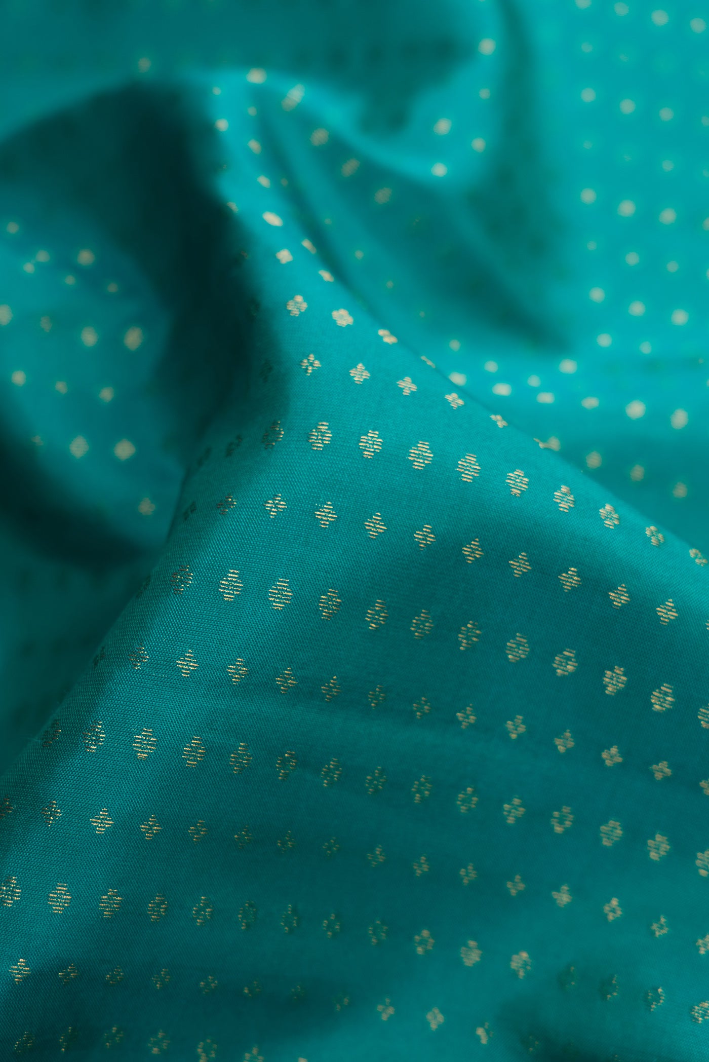 Close up of Green Dual Tone Kanchipuram Silk Saree with Stripes on the body and Zari Border.  displaying folds